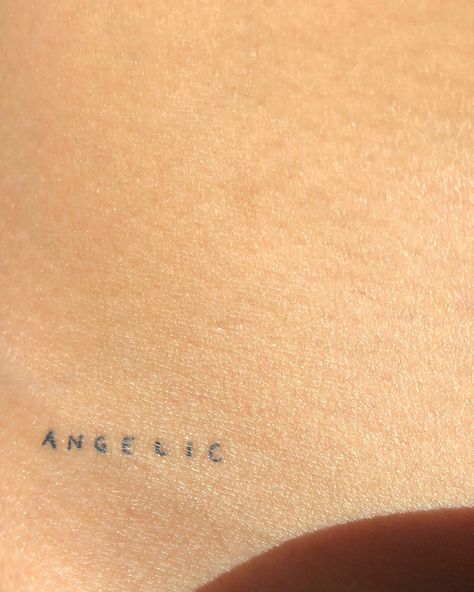 Dainty Words Tattoo, Loved By An Angel Tattoo Words, Angel Tattoo On Hip, Angel Hip Tattoo, Fine Line Lettering Tattoo, Angel Tattoo Writing, Dainty Letter Tattoo, 4 Letter Words Tattoo, Angel Tattoo Word