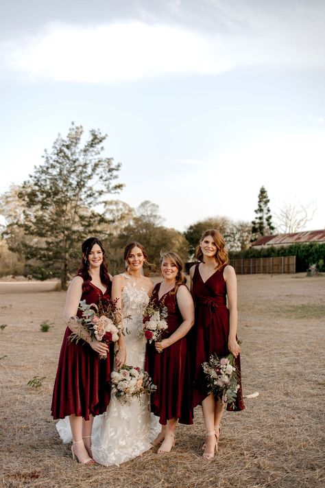 The contrast with the light colour of the bridal gown and the deep red of these bridesmaids is striking! The midi length and the classic deep v- neckline are so classic and stunning. Burgundy Bridesmaids, Midi Bridesmaid Dress, Burgundy Bridesmaid Dresses, Bridesmaids Dresses, Bridal Gown, The Deep, Deep Red, Midi Length, Bridal Party