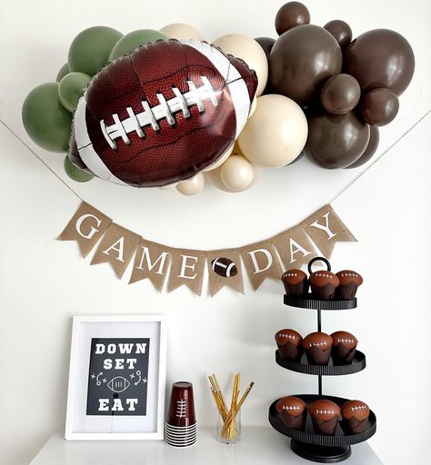 Get your game day celebration ready with our epic party decor!  Complete with sports-themed balloons and a bold 'Game Day' banner, it's the perfect setup to cheer on your favorite team in style.  YOU WILL RECEIVE 1 - Football Balloons, 18 inches An Assortment of Quality Latex Balloons 11 inches and 5 inches 3 ft Balloon Strip Balloon Glue Dots Balloon Garland Instructions Fishing Line One burlap football flags with the words Game Day in white letters. Strings & A Needle for banner assembly Add m First Down Party Decor, Football Tent Decorations, Football 5th Birthday Party, Tailgate Theme Party Decorations, 1 Year Down Football Birthday, Game Day Party Decorations, 1st Birthday Football Theme Food, First Down Party, Sport Birthday Party Ideas