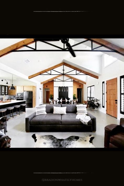 This modern farmhouse has an industrial style decor with modern minimalist touches. The vaulted ceiling features wood and metal beams and black accent features. Polished concrete floors add to the industrial feel of this open concept design. House built by Brandon Whately Homes. #downleahslane #modernfarmhouse #ceiling #industrial #cement #concrete #openconcept #newhouse Ideas For Rooms, Farmhouse Lights, Vaulted Ceiling Beams, Industrial Design Style, Farmhouse Style Lighting, Farmhouse Light, Metal Beam, Industrial Style Decor, Farmhouse Light Fixtures