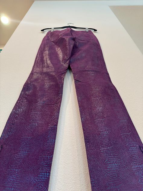 Your song plays and you NEED to hit the dance floor and you NEED to do it in these pants!! Find yourself in these purple iridescent snake skin bootcut leather pants with pockets and side zippers to give a special flare.   All measurements are taken with the garment laying flat. Vintage construction can be very different from modern garments so please be sure to as any questions about stretch of the fabric or fit before purchase. Please note that vintage size labels do not reflect modern sizing and to go by the measurements given. Condition: Excellent Guide to Condition of Vintage Clothing: Mint: Near perfect with normal wear due to age. Excellent: Slight visible wear, 1 or so minor flaws. Very Good: More noticeable wear, some noted flaws but wearable. Good: A few obvious visible flaws. Gar 80s Vintage Clothes, Purple Flare Pants, Purple Leather Pants, Snake Clothes, Iridescent Snake, Vintage Construction, Purple Snake, Disco Pants, Purple Jeans