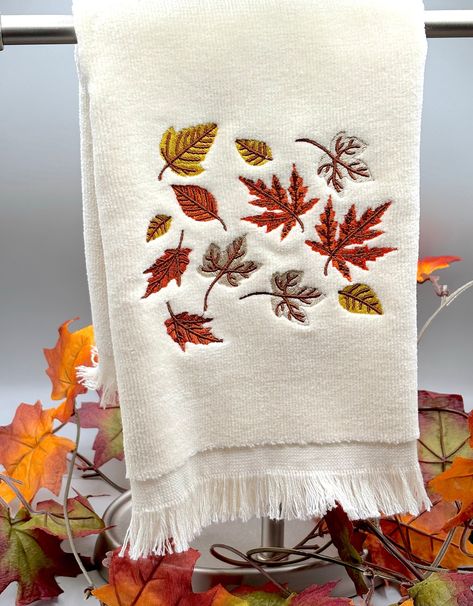 Crunchy leaves, cooler temps, pumpkin spice, its time for Fall! This 18" x 11" fingertip towel is great for your car, bathroom, grill or anywhere you need it. Absorbent for spills or wet hands.  Perfect for gift giving or to give to yourself! The towel is embroidered meaning it is stitched onto the towel for greater durability and years of use Be sure to favorite NanaBee's Embroidery for fast, beautiful gifts or home decor This item was created in a smoke free and pet free environment. Washing instructions: machine wash warm, tumble dry warm PROCESSING TIME IS 2-4 DAYS. THIS DOES NOT INCLUDE SHIPPING TIME WHICH IS 3-5 DAYS Fall Hand Towels, Embroidery Towels Ideas, Embroidery On Towels, Fall Towels, Embroidered Kitchen Towels, Car Bathroom, Crunchy Leaves, Ready For Autumn, Wet Hands