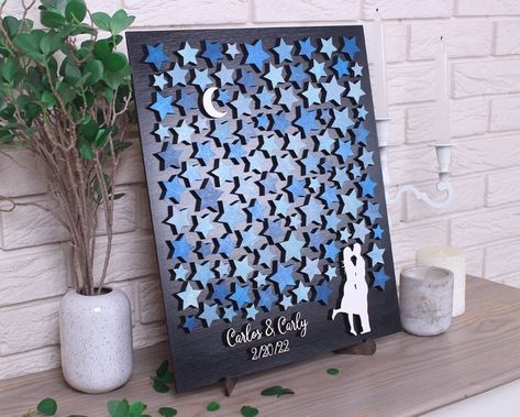 "Celestial wedding guest book alternative Moon and Stars for sign 3D Custom weddung guestbook Bride and Groom Personalized wooden sign This 3d wedding guestbook, a beautiful guest book alternative that is fun for you and your guest. Your guests sign the stars and then you can actually put this wall art into a frame and hang it in your home to enjoy for years to come. You will always remember who shared in your wedding day with you and spouse. We are happy to customize the colors of the guest boo Star Guest Book, Celestial Guest Book Ideas, Book Themed Wedding Guest Book, Celestial Guest Book, Celestial Wedding Guest Book, Moon And Stars Themed Wedding, Stars And Moon Wedding Theme, Celestial Centerpieces, Unique Wedding Guest Book Alternatives