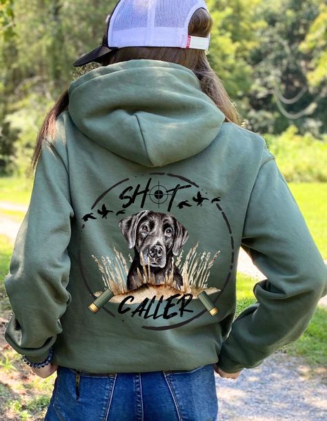 This Shot Caller Military Green Dog Hoodie combines style and functionality. It's perfect for a day outdoors, hunting, or working. The hunter's target and scope print  'Shot Caller' slogan adds a unique finishing touch. Enjoy comfortable, stylish outdoor wear with this military green tee. Introducing our Gildan Ultimate Heavy Blend Hoodie for cozy comfort! Being designed for everyday wear, this hoodie is made from a premium 50/50 cotton-polyester blend, enhancing durability, while also staying super comfortable. This cozy  hoodie provides warmth, a soft feel, and long-lasting comfort and durability.      The hood is double-lined with drawstrings for added warmth and an adjustable fit. Its double-needle stitching on the cuffs and waistband provides extra durability, while the spacious front Hunting Women Outfit, Women’s Hunting Outfits, Long Sleeve Winter Hunting Outerwear, Upland Bird Hunting Clothing, Shot Caller, Duck Hunting Outfit, Hunting Hoodies, Duck Hunting Shirts, Mens Dress Hats