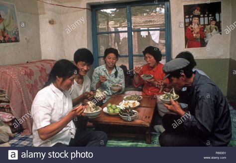 Northern China 1980 Commune in Waoning Province in an interior of a home where a family are eating a meal sitting on a kang a bed stove which is a platform made of brick where funnelled air is fuelled by a fire providing heat, usually wood fire. Stock Photo Chinese House, Chinese Home, Fire Stock, A Fire, Vintage Photography, Vintage Photos, A Family, Fuel, Photo Image