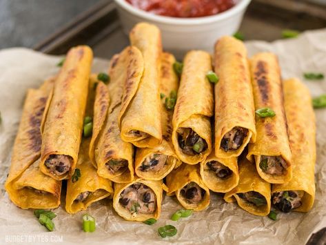 Creamy Black Bean Taquitos are an easy and tasty party treat for football games or just for fun! BudgetBytes.com Black Bean Taquitos, Inexpensive Appetizers, Bean Taquitos, Taquitos Recipe, Budget Bytes, How To Cook Beans, Bean Recipes, Black Bean, Vegan Dinners