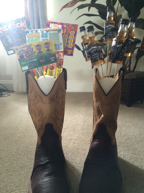 Jack Daniels bouquet in cowboy boots and scratch offs and slim Jims and Pepsi in the other Men’s Bouquet Ideas, Cowboy Boyfriend Gifts, Jack Daniels Bouquet, Cowboy Gifts For Men, Western Gift Basket, Gifts For Country Boyfriend, Cowgirl Essentials, Country Boy Gifts, Country Boyfriend Gifts