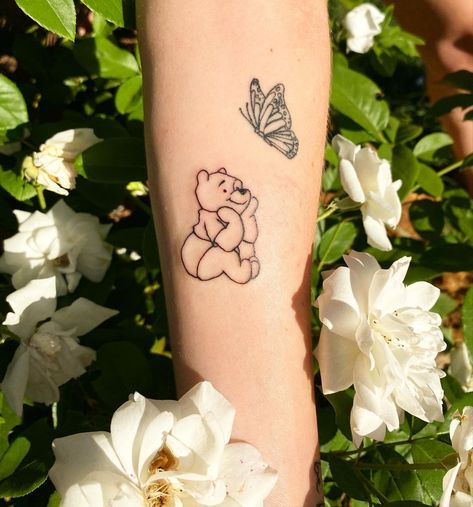 210+ Best Winnie The Pooh Tattoo Designs (2024) - TattoosBoyGirl Winnie The Pooh With Butterfly Tattoo, Winnie The Pooh Butterfly Tattoo, Bear And Butterfly Tattoo, Pooh Bear Tattoo, Mums Tattoo, Pop Tattoo, Bear And Butterfly, Cute Disney Tattoos, Winnie The Pooh Tattoo