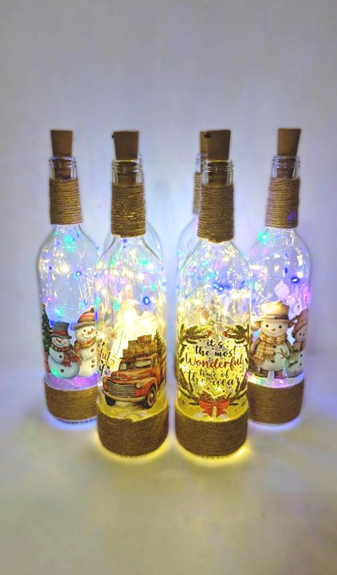 Unique Handcrafted Light Up Wine Bottle. SET OF TWO for the price. Please choose your choice. :) Thank you. ALL OF MY ITEMS ARE FREE SHIPPING. ENJOY! :)  * One of a kind and ready to ship. * Beautiful decal and heat transfer elements placed and arranged by hand. * Battery powered ( 3 of LR44 included) and easy to be replaced. * Perfect for gift * Can also be shipped as gift with a tag/card. Send me a message for this. :) Technical Details: * Dimensions:  Size - 3" Width x 12.5" Height . * Materials: Glass bottle, cotton thread, heat transfer decals, battery powered fairy light **Color and texture can be slightly different due to photographic lighting sources or your screen settings. Due to the nature of handcrafted products, slight variations can occur and should be expected. Please contac Old Glass Bottles Ideas, Painting Wine Bottles, Whiskey Bottle Crafts, Bottle Snowman, Decorated Wine Bottles, Lighted Bottles, Handmade Christmas Decor, Wine Bottle Lights, Wine Bottle Crafts Christmas