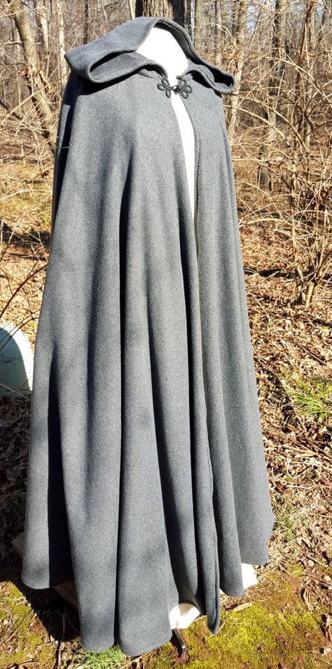 This long dark grey cloak is a full circle of soft warm fleece, giving it wonderful movement and flow. This full length cloak is 58 long. It has a full hood and closes with a matching cloth frog. This cloak is a great costume piece for your local renaissance faire or festival and is comfortable for Long Hooded Cloak, Cloak Pattern, Chica Dark, Long Cloak, Winter Cloak, Medieval Cloak, Hallowen Costume, Hooded Cloak, Period Outfit