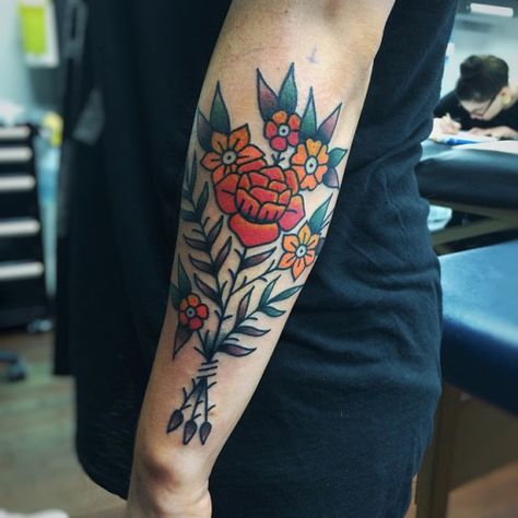 Simple, traditional flower bouquet tattoo on the left forearm Traditional Tattoo Flower, Traditional Color Tattoo, Tattoo Flower Bouquet, Tattoo Elbow, Flower Bouquet Tattoo, Traditional Tattoo Flowers, Traditional Style Tattoo, Traditional Flower, Bouquet Tattoo