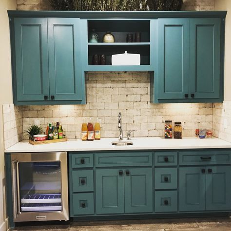 Green-blue wet bar cabinets with TaylorCraft’s MW15 and FP1/4 mitered door profiles and cream tumbled travertine backsplash Wet Bar With Green Cabinets, Greenish Blue Cabinets Kitchen, Blue And Green Kitchens, Green Wet Bar Cabinets, White Cabinets Teal Backsplash, White Kitchen Cabinets Teal Backsplash, Blue Green Kitchen Cabinets, Tealkitchen Cabinets, Green Country Kitchen