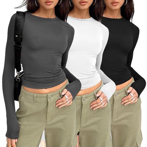 PRICES MAY VARY. Soft Material: Womens tight long sleeve shirts is made of high quality polyester fabric. Soft and elastic, lightweight and Comfortable to wear. Cute Design: Cropped and stretch fitted style,crew neck, tight underscrubs layer,you can wear it regularly or fold it up like a crop top,cute,slim fit,casual y2k style fashion 2024. Matching: This womens long sleeve tops, tunic tops to wear with leggings, your favourite jeans, hat, With a necklace, Sunglasses, Up with heels or sneakers f Black Undershirt, Basic Crop Tops, Knit Shirts, Collared Shirts, Black Shirts, Y2k Tops, Compression Shirt, Cropped Tops, Basic Shirts