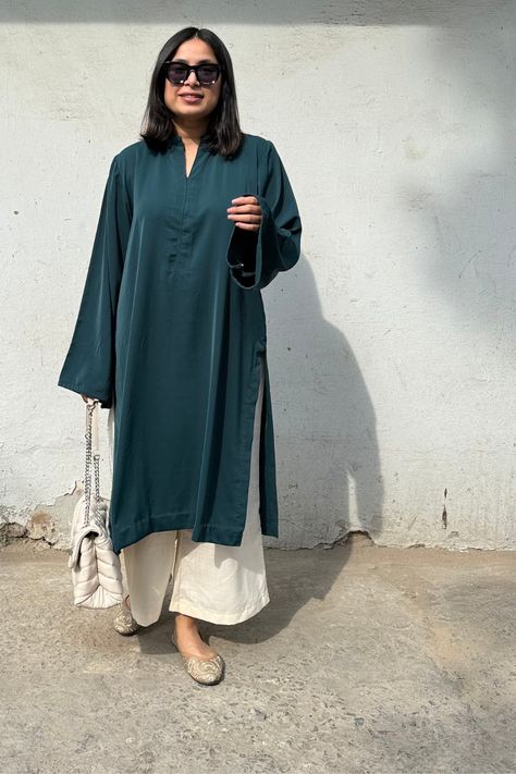 Solids Kurta Set is a comfortable coord set for women, available in a rich dark green. Both kurta and pants are crafted from a poly crepe and cotton blend, ensuring a breezy and flowy fit that's perfect for summer. The set features lace frill detailing on the sleeves, kurta, and pants, adding a refined touch. Ideal for those searching for coord sets online in India, this set combines both comfort and sophistication seamlessly. Soft fabric and unique design makes it a great choice for any occasion.

The fit is Middle Eastern and oversized.
Since this product is dyed, slight color variation might be possible.


Fabric: Poly crepe/Cotton mixed crepe Crepe Suit Design, Casual Kurta Sets For Women, Oversized Kurta Women, New Stylish Kurtis Design Latest, Pant Kurti Designs Latest, Pakistani Cord Set, Unique Kurta Designs Women, Basic Office Outfit, Cotton Kurta Sets For Women