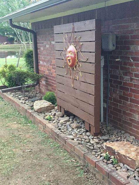 We wanted to somewhat hide the ugly electric meter and cable box, this did the trick after purchasing a large metal sun. Hubby built this out of treated lumber and we both stained it. Hiding Electrical Box On House, Large Backyard Landscaping, Electrical Box Cover, Large Backyard, Casa Exterior, Patio Designs, Backyard Projects, Yard Ideas, Diy Backyard