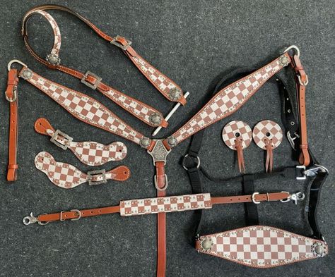 Showman    ® Brown & White Checker Print One Ear Headstall and Breast Collar 7-piece set. This set features medium leather with a brown and white checkered print overlay. Set includes one ear headstall, breast collar, bit guards, spur strap, wither strap, bronc halter & 5/8" x7" split reins.       CLEARANCE      This is a Closeout/Discontinued item. Sizes, colors and quantities are limited.  No refunds/No exchanges on Closeout/Discontinued items. Products are sold as is. Western Riding Tack, Barrel Racing Tack Rodeo, Bling Horse Tack, Leather Horse Tack, Bronc Halter, Saddle Bags Horse, Western Spurs Straps, Roping Saddles, Barrel Racing Saddles