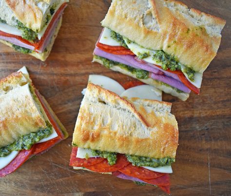 Italian Pressed Sandwiches made with rustic French bread layered with Italian meats and cheeses, pesto sauce or olive oil and vinegar, and marinated tomatoes. This Italian Pressed Sandwich with pesto sauce is perfect for a picnic, kids lunch, or for a casual lunch. www.modernhoney.com Italian Sandwich Bread, French Bread Sandwich, Pressed Sandwiches, Roll Sandwiches, Sandwiches Ideas, Summer Picnic Food, French Bread Loaf, Modern Honey, Rolled Sandwiches