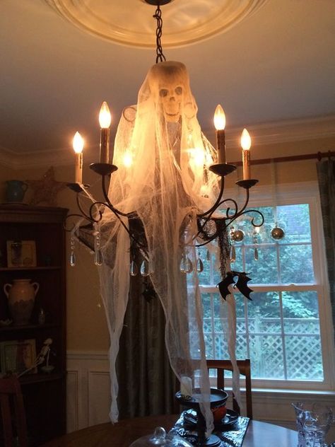 80+ Spookiest DIY Halloween Decorations That Will Give You Goosebumps - Hike n Dip Halloween Decorations For A Restaurant, Halloween Chandelier Decorations, Skeleton Chandelier Diy, Halloween Chandelier Ideas, Witchy Chandelier, Chandelier Halloween Decor, Skull Chandelier Diy, Restaurant Halloween Decor, Halloween Restaurant Decorations