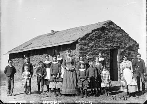 Circa 1889. Sod school, District 62, 2 miles west of Merna, Custer County, Nebraska. Teacher identified as Elsie Thomas, who later married a Mr. Bidgood. The girls in the back row, second to the left of the teacher is Nettie Hannawald. Solomon D. Butcher Nebraska State Historical Society, [Digital ID: nbhips 11996] www.loc.gov #American #History #Nebraska American Pioneers, Photo Of People, Pioneer Days, Pioneer Families, Pioneer Life, Country School, The Oregon Trail, Small Building, Old School House