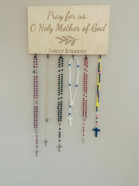 "A great addition to your prayer corner to display all of your family rosaries! You decide what gets engraved under the leaf image! This rosary holder is 15\" x 8\" x 0.5\" and is laser engraved on birch wood. You decide how many hooks you would like. The photo for this listing shows 6, but up to 8 can easily be added. Each rosary holder comes with a sawtooth hook installed for easy hanging. Each piece of wood has its own knots and color variations, which will make each rosary holder unique. *rosaries not included" Catholic Prayer Corner, Rosary Holder, Catholic Wedding Gifts, Catholic Christmas Gifts, Home Altar Catholic, Catholic Christmas, School Prayer, Catholic Decor, Prayer Corner