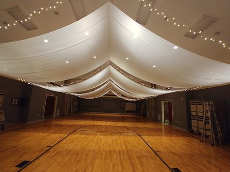 LDS cultural hall ceiling draping for wedding. Starts at only $400. Creativeweddingandpartydecor.blogspot.com Wedding Hall Draping Ceiling Decor, Lds Reception Cultural Hall, Draping With Lights, Lds Wedding Reception Cultural Hall, Ceiling Draping Wedding, Marquee Styling, Event Moodboard, Raven Wedding, Lds Weddings Reception