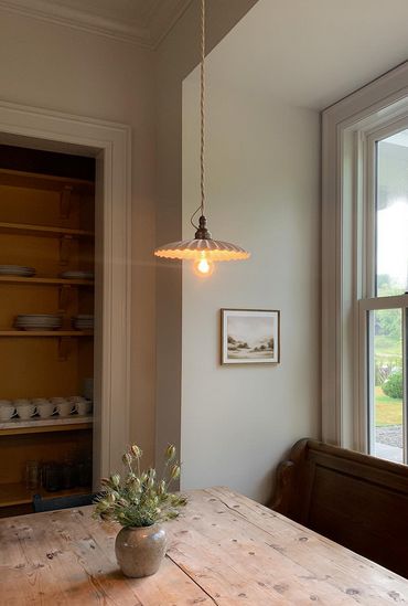 This vintage pleated pendant light exudes charm with its 7.8" white ceramic pleated shade and E26 brass lamp holder. Ideal for kitchens, bedrooms, and farmhouse settings, it offers vintage style and functional illumination. Personalize the lighting ambiance with your chosen bulb. Elevate your space with this classic yet elegant pendant light. — This pin includes an affiliate link eligible for commission 𝘗𝘩𝘰𝘵𝘰 𝘣𝘺 𝘌𝘮𝘦𝘭𝘪𝘦 𝘚𝘶𝘯𝘥𝘣𝘦𝘳𝘨 Kitchen Island Vintage Lighting, Vintage Inspired Pendant Light, Pleated Pendant Light, Kitchen Sink Pendant Light, Emelie Sundberg, Kitchen Island Vintage, Lights Over Dining Table, Porcelain Pendant Light, Lighting Ambiance