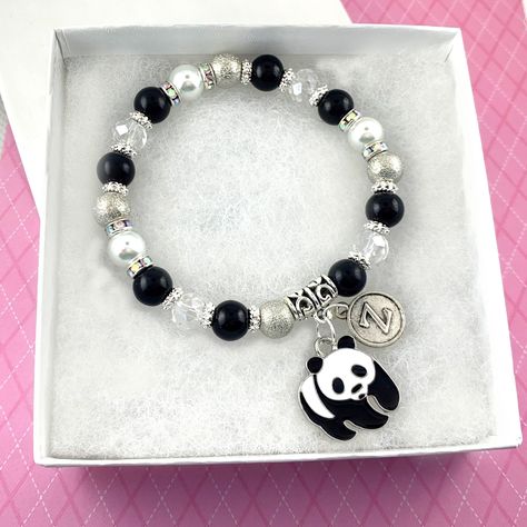 "Panda Bracelet, Personalized Gifts, Panda Lover Gift, Cute Panda Little Girl Jewelry, Initial Bracelet, Black and White Beaded Bracelet ----- This sweet panda bear beaded charm bracelet comes with an antique silver typewriter style initial to personalize your gift and make it extra memorable for the cute animal lover in your life! INCLUDES: 🌸 One black, white pearl, silver stardust and crystal glass beaded stretch bracelet; 🌸 A black, white and silver enamel panda bear charm, and an antique s Panda Gift Ideas, Panda Clothes, Black And White Beaded Bracelet, Panda Bracelet, Black Beads Bracelet, Panda Jewelry, Panda Stuff, Panda Items, White Beaded Bracelet