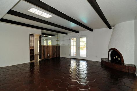 love the hexagon Saltillo tiles and kiva fireplace. Dark beams and white paint. Staining Terracotta Tiles, Dark Beams, Fireplace Dark, Saltillo Floor, Farmhouse Bathroom Light, Mexican Tile Floor, Rachel House, Painting Light Fixtures, Western Bathroom Decor