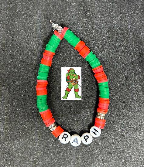 Raphael (TMNT) Heishi Bracelet #handmadebracelet #heishibracelets #beadedbracelets #bracelets #personalizedbracelets #personalizedbracelet #raphael #raphaeltmnt #tmnt #tmntraph #teenageninjamutantturtles #teenageninjaturtles Ninja Turtle Bracelet, Tmnt Bracelet, Bead Business, Raphael Tmnt, Clay Bracelets, Heishi Bracelet, Kandi Kid, Preppy Bracelets, Bracelets Ideas