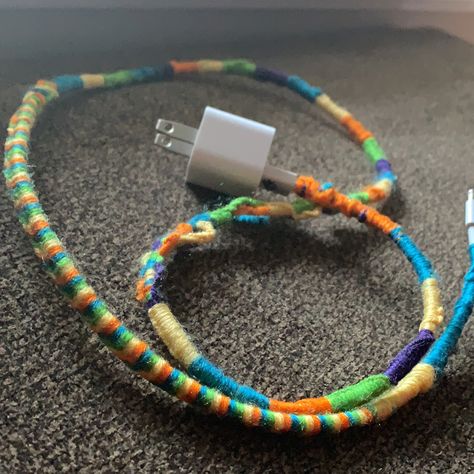 Using multiple colors of yarn i decorated my charger cord. No more sticky fingers 😂✊🏽 Charger Cord Wrap, Diy Chargers, Cords Crafts, Sticky Fingers, Cord Wrap, Charger Cord, Suede Cord, Getting Old, No More