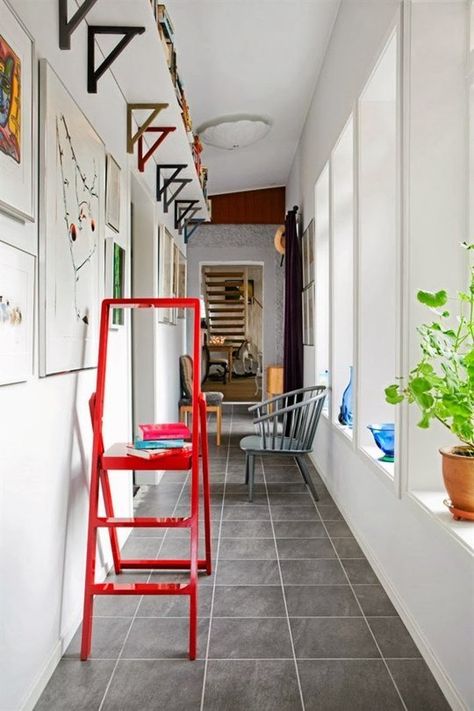 For a little extra storage, mount a shelf just below the ceiling along the length of a room. If your ceilings are tall enough, you'll barely notice it. This works especially well in a hallway, as spotted on Hus & Hem. Small Hallway Ideas, Space Apartments, Small Entryways, Hallway Storage, Small Hallways, Small Entryway, Small Space Solutions, Narrow Hallway, Small Space Living