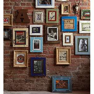 Wall Collage. I love the randomness of the frames and the mix of shapes. Gallery Wall Brick, Frames On Brick Wall, Photos On Brick Wall, Exposed Brick Gallery Wall, Funky Frames, Monster Photo, Wall Frame Design, Brick Wall Decor, Brick Feature Wall