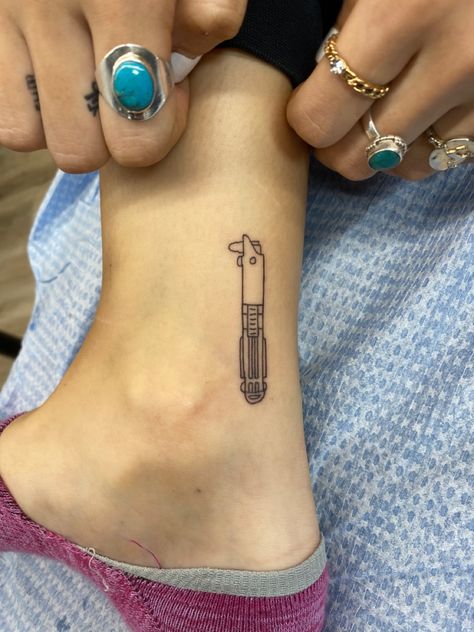 Minimal Lightsaber Tattoo, Matching Lightsaber Tattoos, Star Wars Tramp Stamp, Rey Lightsaber Tattoo, Star Wars Stick And Poke Tattoo, Minimalist Lightsaber Tattoo, Leia Tattoo Minimalist, Starwars Tattoo Small Anakin, Star Wars Small Tattoo Ideas