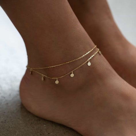 Dress up plain pumps or flats with this chic anklet featuring dangling polished discs on a layered chain. Thick layer of 14K Gold over .925 Sterling Silver 4mm Discs Hypoallergenic, lead, and nickel free Length: 9in (22cm) + Extension: 1in (2.5cm) Lobster clasp closure Handcrafted in NYC #ANK014 Flat Gold Bangles, Gold Jewelry Hoco, Ankle Bracelets Aesthetic, Anklet Aesthetic, Anklets Aesthetic, Aesthetic Anklets, Minimal Anklet, Gold Ankle Bracelets, Anklets Gold