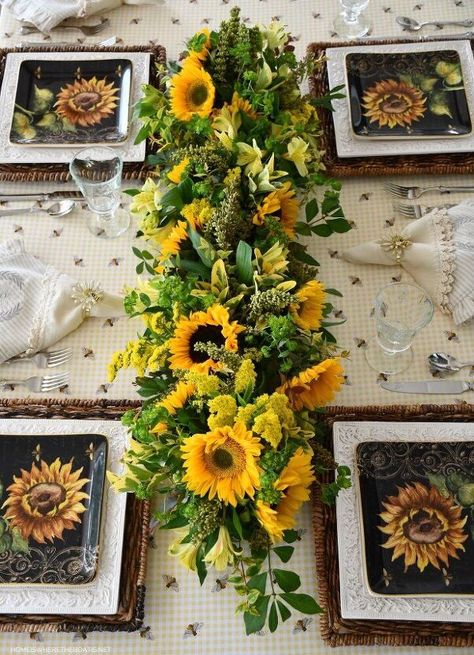 Learn how to create a fresh floral table runner and centerpiece with an eco-friendly tool, chicken wire. I had a blog challenge to create a flower arrangement using sunflowers. I decided to create floral runner to sit low enough on the table as to not block anyone’s view. To create this runner I used my favorite flower arranging tool, chicken wire. Chicken wire is an eco-friendly alternative to wet floral foam as it can be reused.You can find chicken wire in small rolls at the… Tablescape Flowers, Bees Diy, Diy Floral Centerpieces, Tablescapes Summer, Bee Ideas, Sunflower Designs, Sunflower Centerpieces, Summer Tablescapes, Sunflower Arrangements