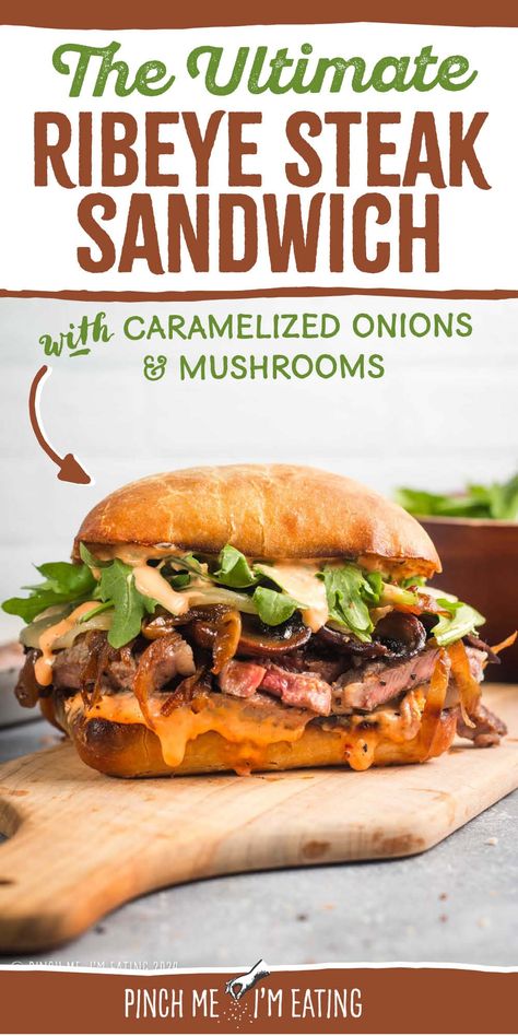 This grilled ribeye steak sandwich is loaded with roasted red pepper garlic aioli, arugula, provolone, caramelized onions, and mushrooms, all on a toasty ciabatta roll. You can even use thinly sliced leftover steak in this recipe! This sandwich is a great main course dish, and the sauce is out of this world! Steak Sandwich With Garlic Aioli, Ribeye Sandwich Recipe, Ribeye Sandwich, Ribeye Steak Sandwich, Caramelized Onions And Mushrooms, Steak Sandwich Recipes, Grilled Ribeye Steak, Ciabatta Roll, Grilled Ribeye