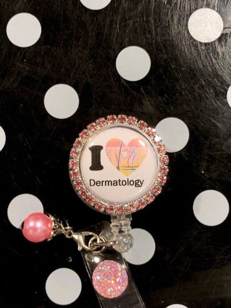 I heart dermatology retractable badge reel makes a practical gift for anyone who uses a name tag, keychain, scissors for sewing or use to keep track of your ink pen. Button is 1 1/4 inch in diameter. spring swivel clip. Tab Jewelry, Stethoscope Id Tag, Bling Design, Retractable Badge Reel, Rhinestone Designs, Clear Vinyl, Dermatology, Id Holder, Name Tag