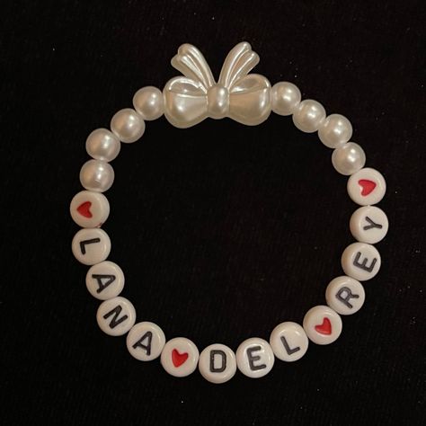 Handmade Beaded Bracelet - Perfect for Lana Del Rey fans! 🎀 ✨ Your wrist could not look any prettier with this elegant faux pearl bracelet. Share your love for Lana Del Rey in style! Each bracelet is handmade to order to the standard size of 17cm. The elastic does stretch but if you require a smaller or larger size please note in the personalisation section.  All bracelets comes in a beautiful, pink, drawstring bag 💘 Note: I recommend rolling the bracelet over your wrist rather than stretching it to minimise possible damage. ❤︎ Feel free to message me with any queries ❤︎ Bracelet Ideas Lana Del Rey, Lana Del Ray Bracelet, Lana Del Rey Beaded Bracelet, Lana Del Rey Jewelry, Lana Del Rey Bracelet, How To Make Bracelets With Beads, Handmade Bracelets Ideas, Lana Bracelet, Pearl Bracelet Ideas