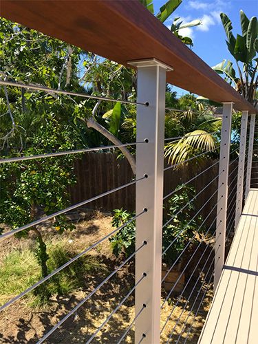 Cable railing systems cost factors vary depending on the materials selected. San Diego Cable  railing systems cost compete with any comparable railing. Cable Railing Deck, Farmhouse Landscape, Lighting Farmhouse, Deck Railing Design, Cable Railing Systems, Building A Porch, Railings Outdoor, Farmhouse Landscaping, Porch Railing