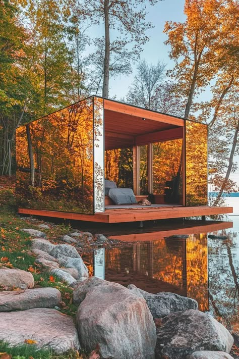 Modern forest lakeside cabin with one site full wall mirror reflecting the lake shore. Peek into the world of glass cabins and see how these transparent wonders turn living spaces into magical panoramas of nature. Small Lakeside Cabin, Dark Modern Farmhouse, Glass Cabins, Full Wall Mirror, Glass Cabin, Cabin Tiny House, Mountain Cabins, Lakeside Cabin, Dark Modern