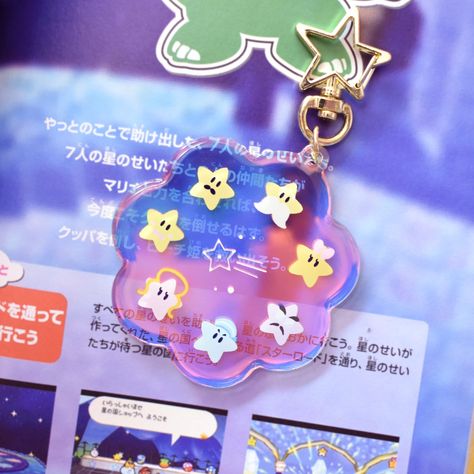 An irridescent keychain featuring the 7 stars of Star Haven~  ☆2.5" size ☆Gold star shaped clasp ☆Protective epoxy layer ☆Iridescent rainbow acrylic SHIPPING (⊃｡*́‿*̀｡ﾟ.*･｡ﾟ 📦 ☆Items take 1-5 business days to ship  ☆Shipped from Canada  ☆Within CANADA - Estimated delivery depends on your chosen shipping method, location, and other possible delays outside our control -Letter mail (UNTRACKED) : up to 3 weeks, only small items can be shipped with this economical option -Tracked packet: Estimated delivery 7 business days ☆Within USA - Estimated delivery depends on your chosen shipping method, location, and other possible delays outside our control -Letter mail (UNTRACKED) : this economical option is only available for stickers, takes up to 4 weeks to arrive -USA Tracked packet: Estimated deli Galaxy Keychain, Cosmic Space, Kawaii Accessories, Acrylic Keychain, Cute Keychain, Acrylic Charms, Mail Letters, Gold Star, Gold Stars