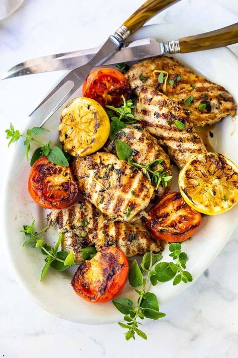 How to make the Best Grilled Chicken- flavorful and juicy every single time! A simple, easy recipe made with chicken breast, garlic, herbs and lemon! #grilledchicken Grilled Lemon Herb Chicken, Chicken With Roasted Vegetables, Grilled Lemon Chicken, Feasting At Home, 300 Calorie Meals, Grilled Lemon, Lemon Herb Chicken, Herb Chicken, Lemon Herb