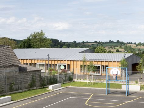 The school complex is situated in the small village of Viessoix in the hills of the Normandy region of western France. The new project was intended to replace and combine into a single entity a number of outdated schools located in adjacent villages. Kindergarten Architecture, Western France, School G, School Architecture, New Project, The Hills, Elementary School, Elementary Schools, Kindergarten