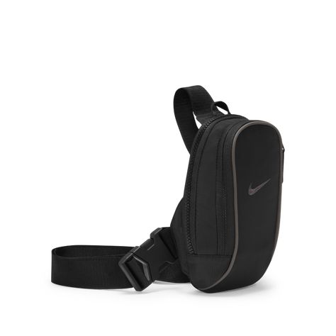 The Nike Sportswear Essentials Cross-Body Bag features 2 zip pockets to let you keep the small stuff organised and easy to grab. The accessory pocket zip pull offers quick access to smaller items, while an adjustable strap and buckle provide an easy-on-and-off fit. This product is made from at least 50% recycled polyester fibres. An internal storage compartment makes it easy to store and grab your wallet or phone. Adjustable strap provides styling and fit options. 20cm H x 13cm W x 5cm D (appro… Nike Crossbody Bag, Small Stuff, Mens Home, Kids Trend, Sunglass Hut, Mens Trends, Wedding Watch, Sportswear Women, Black Cross Body Bag