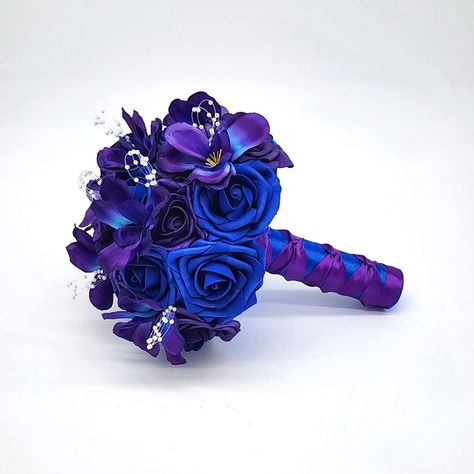 Stunning Royal Blue & Purple Wedding Bouquet Elevate your special day with this captivating Royal Blue & Purple Wedding Bouquet. Crafted with meticulous attention to detail, this bouquet is a perfect blend of elegance and uniqueness, designed for brides who want to make a bold statement. Matching Boutonnieres and Corsages Available. Features: Vibrant Colors: The rich hues of royal blue and purple create a striking contrast, making this bouquet a standout accessory. Quality Materials: Made from h Royal Blue And Purple Wedding, Blue And Purple Wedding Theme, Purple And Blue Wedding, Blue And Purple Wedding, Royal Purple Wedding, Roses Bridal Bouquet, Dark Purple Wedding, Orchid Boutonniere, Wedding November