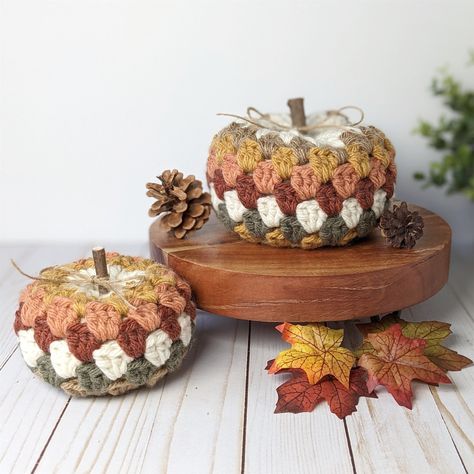 Bring the cozy charm of autumn into your home with these unique granny square style Fall crochet pumpkins. - Handcrafted from premium yarn in muted Fall colors - Simple farmhouse design adds instant coziness and character - Perfect for displaying on mantels, shelves, tables, trays and more - Distinctive granny square style creates a unique one-of-a-kind pumpkin These adorable yarn pumpkins are the perfect way to bring warmth and coziness to your home this harvest season. Crocheted in muted, Fall tones, they'll blend seamlessly into your existing Fall décor. Whether you place them on your fireplace mantel, bookshelf, or entryway table, they'll bring a warm, inviting ambiance to any room. Tuck them into your coffee table centerpieces or pile them on your favorite trays for a beautiful autumn Crochet Pumpkin Centerpiece, Yarn Pumpkins, Mantel Bookshelf, Farmhouse Pumpkins, Cozy Fall Home, Crochet Autumn, Crochet Blanket Stitch Pattern, Stuffed Pumpkin, Autumn Farmhouse