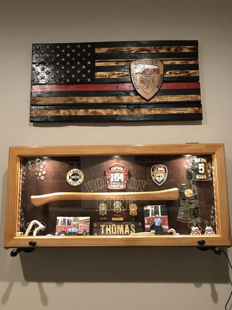 Firefighter shadow boxes and firefighter flag Firefighter Decor House, Shadow Box For Firefighter, Firefighter Office Ideas, Firefighter Display Ideas, Fire Department Shadow Box Ideas, Firefighter Plaque Ideas, Firefighter Man Cave Ideas, Firefighter Home Decor Ideas, Firehouse Decor Ideas