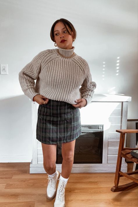 Woman with low bun and curtain bangs wearing green plaid mini skirt, beige chunky sweater, and beige combat boots Beige Combat Boots, Chunky Sweater Outfit, Dark Academia Vibes, Edgy Fits, Beige Boots, Plaid Pullover, Sweater Outfit, Plaid Mini Skirt, 2024 Fashion