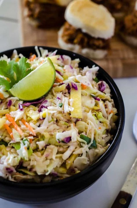 Bring the best dressed slaw to your next BBQ! This fast & easy Fresh Pineapple Coleslaw adds a little tropical flair to the otherwise ordinary side, making it a great topping for everything from sliders to hot dogs! Pulled Pork Side Dishes, Tropical Slaw, Fresh Pineapple Recipes, Pineapple Coleslaw Recipe, Pork Side Dishes, Pineapple Slaw, Pineapple Coleslaw, Barbecue Side Dishes, Pineapple Recipes