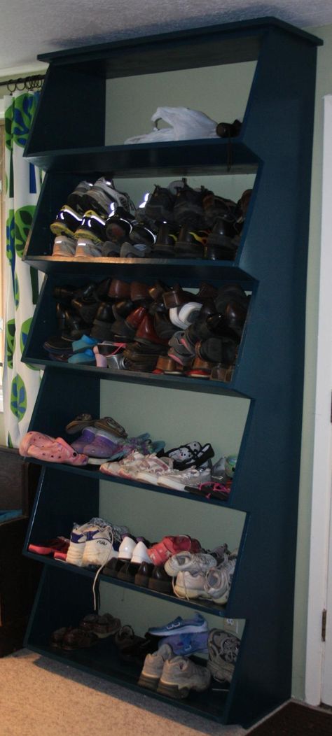 I need need need this in my basement! :Floor-to-ceiling Shoe Shelf with Angled Front Shelf Shoe Rack Plans, Garage Shoe Rack, Garage Shoe Storage, Family Closet, Diy Shoe Rack, Shoe Storage Solutions, Garage Storage Organization, Shoe Shelf, Diy Flooring